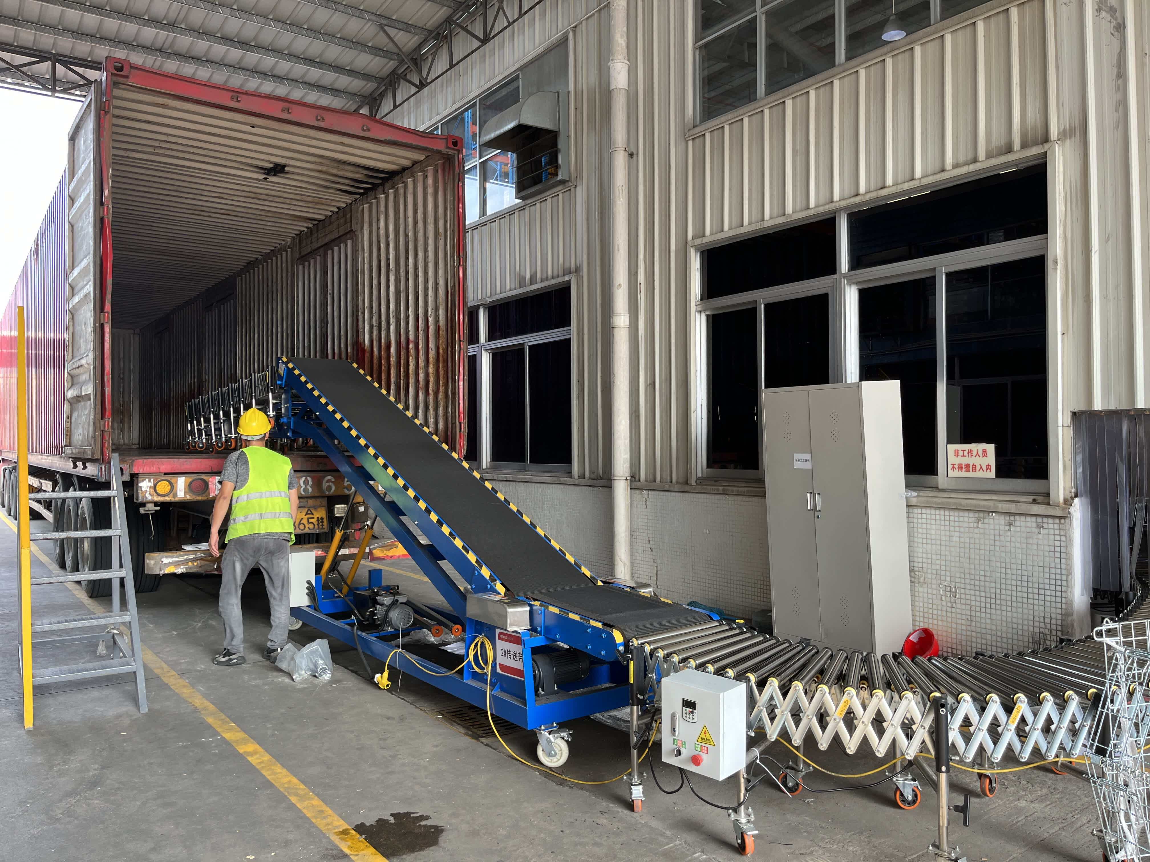 Roller conveyor extending into the side of the truck, showing in-truck docking operation