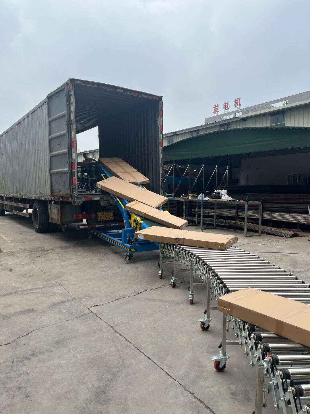 Loading a truck with a powered roller conveyor